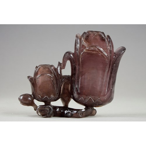 Amethyst group forming double vase depicting two magnolia flowers and branches